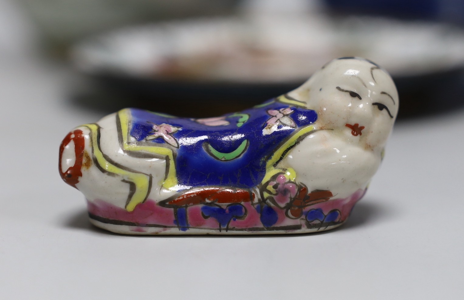 A 19th century Chinese famille rose box and cover, a blue and white prunus jar, two other jars, a figural brush rest and a cloisonne enamel dish